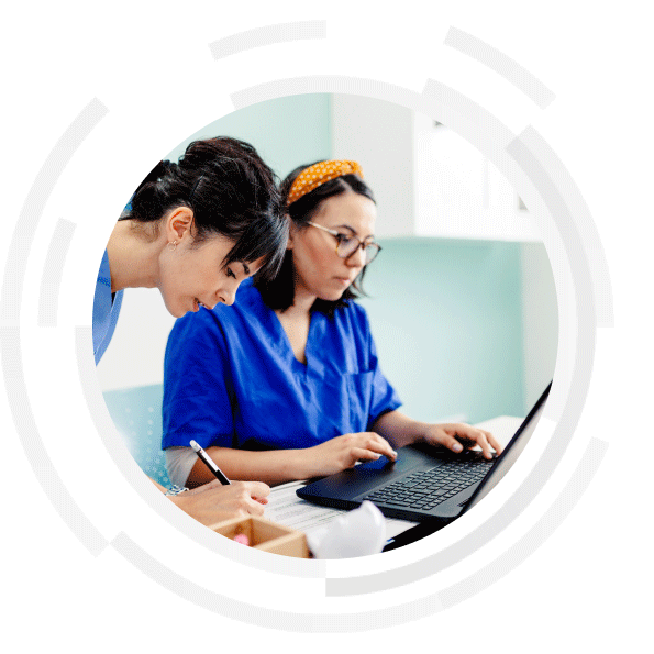 Two clinicians performing data entry in a hospital office