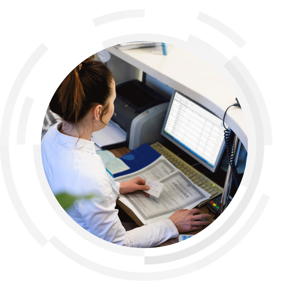 Female clinician entering data on a desktop computer.