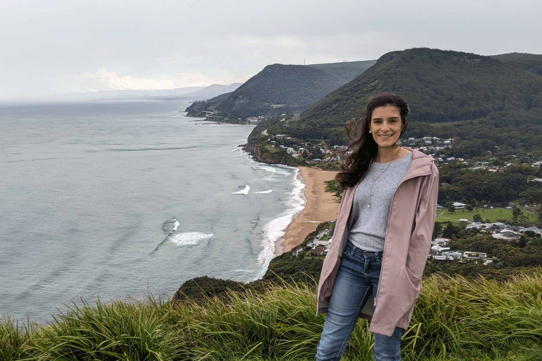 Woman smiling on cliff lookout point