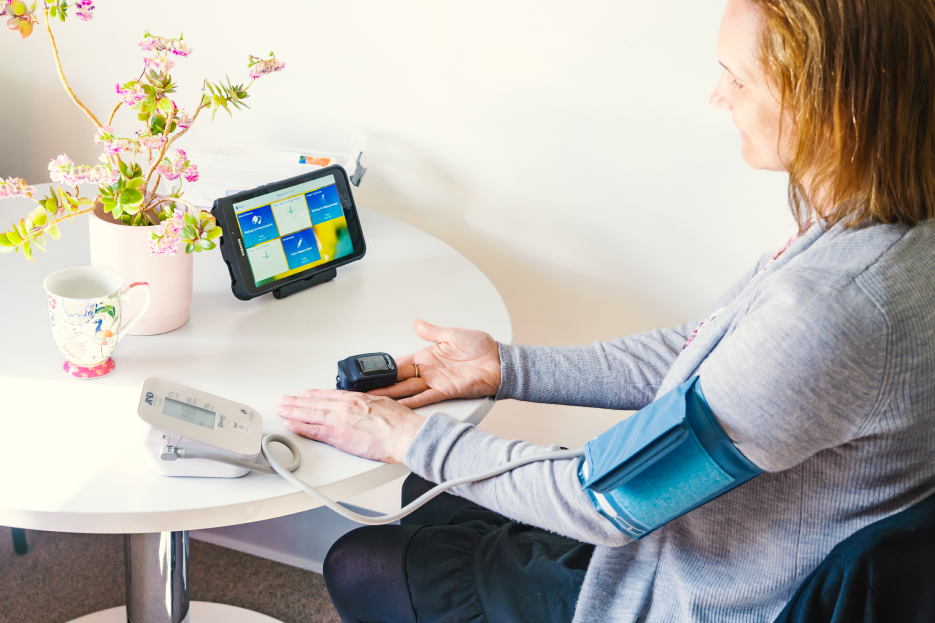 Woman checking her blood pressure at home