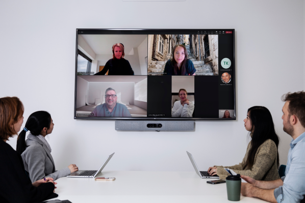 People looking at a video conference screen