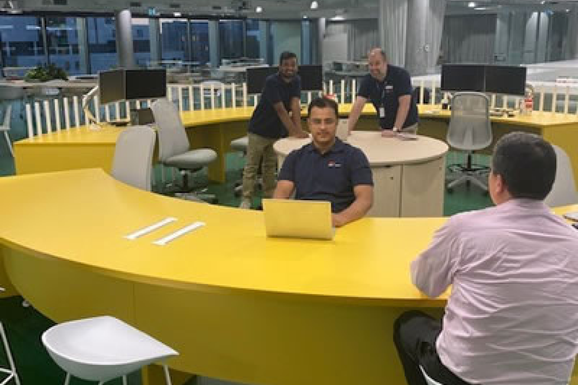 Abilash Rao Vavilala, Yaseen Syed and Graeme Burt provide IT support to one of the Connect IT Hub’s first customers at 1 Reserve Road
