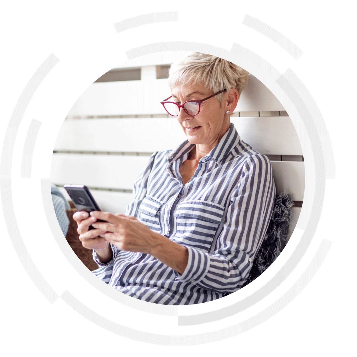 Elderly woman wearing red glasses scrolling on mobile phone.