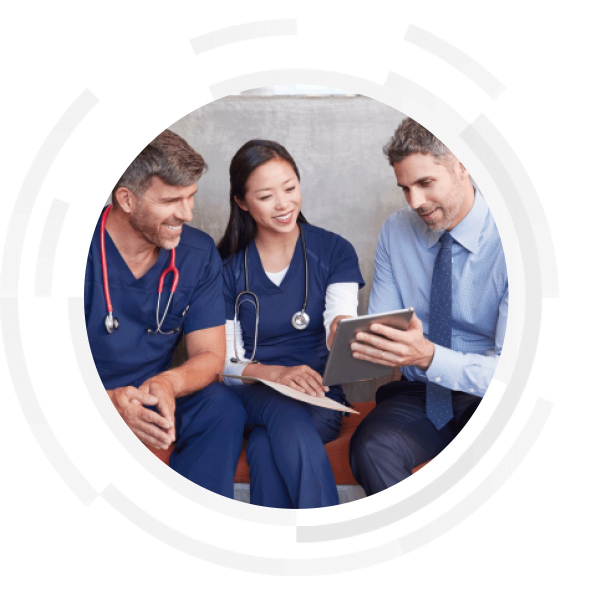 Group of three clinicians smiling and looking at a tablet.