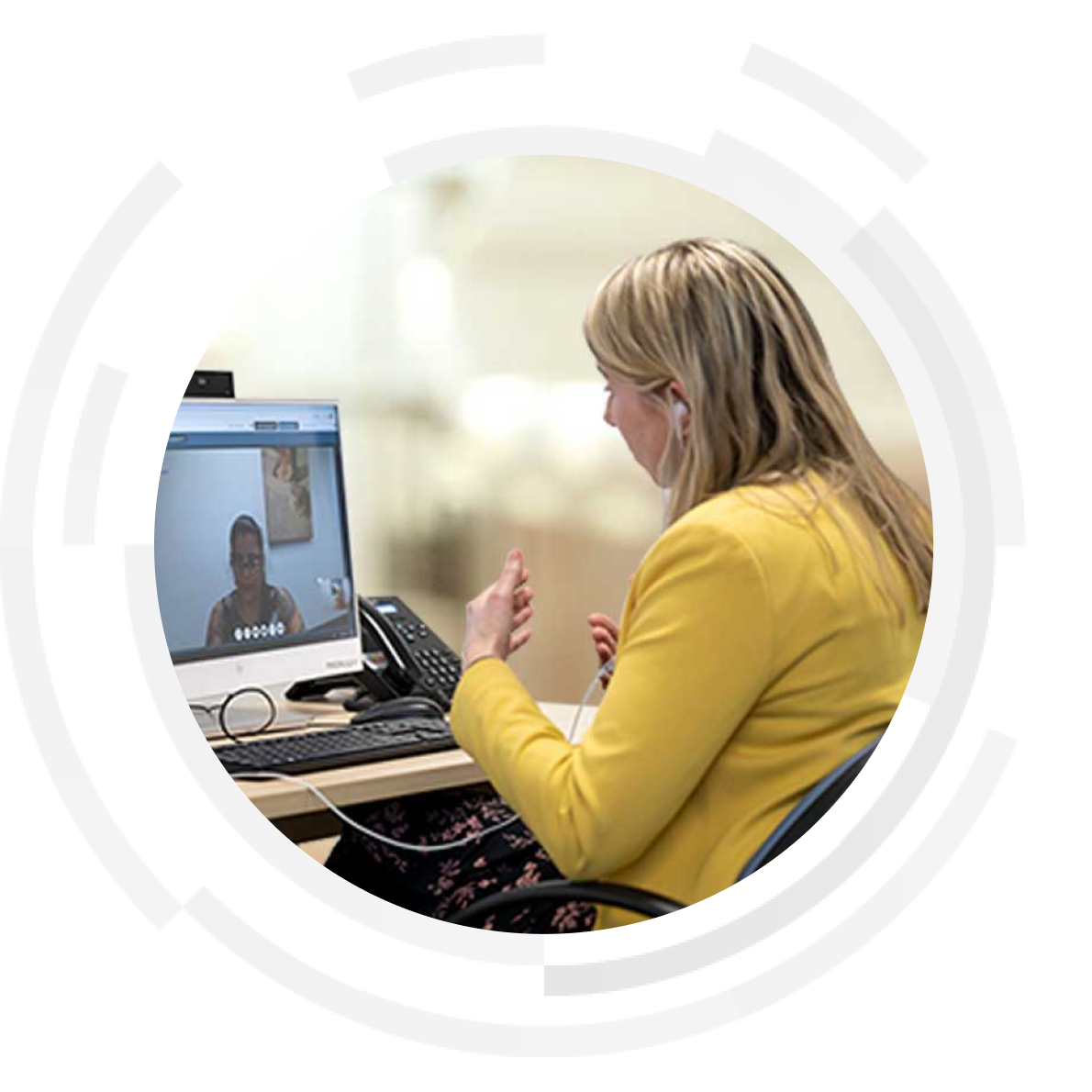 Doctor conducting a virtual consultation with patient on a desktop computer.