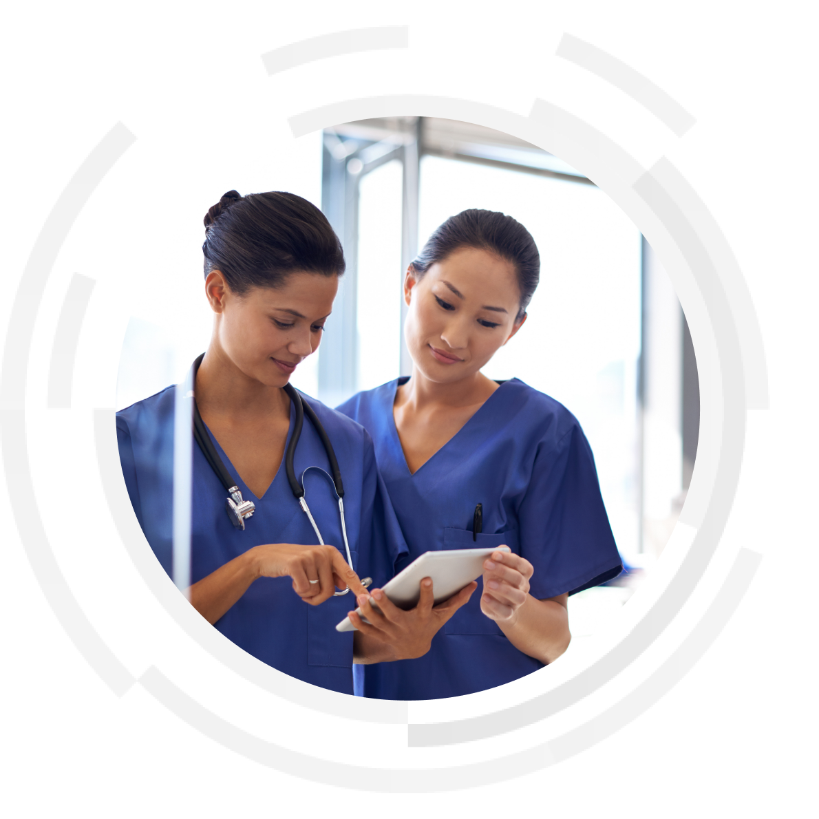 Shot of two female nurses using a tablet to review medical records.
