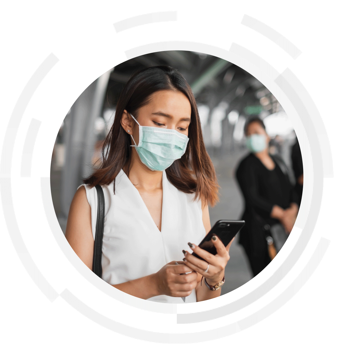 Woman wearing a mask scrolling on her mobile phone.