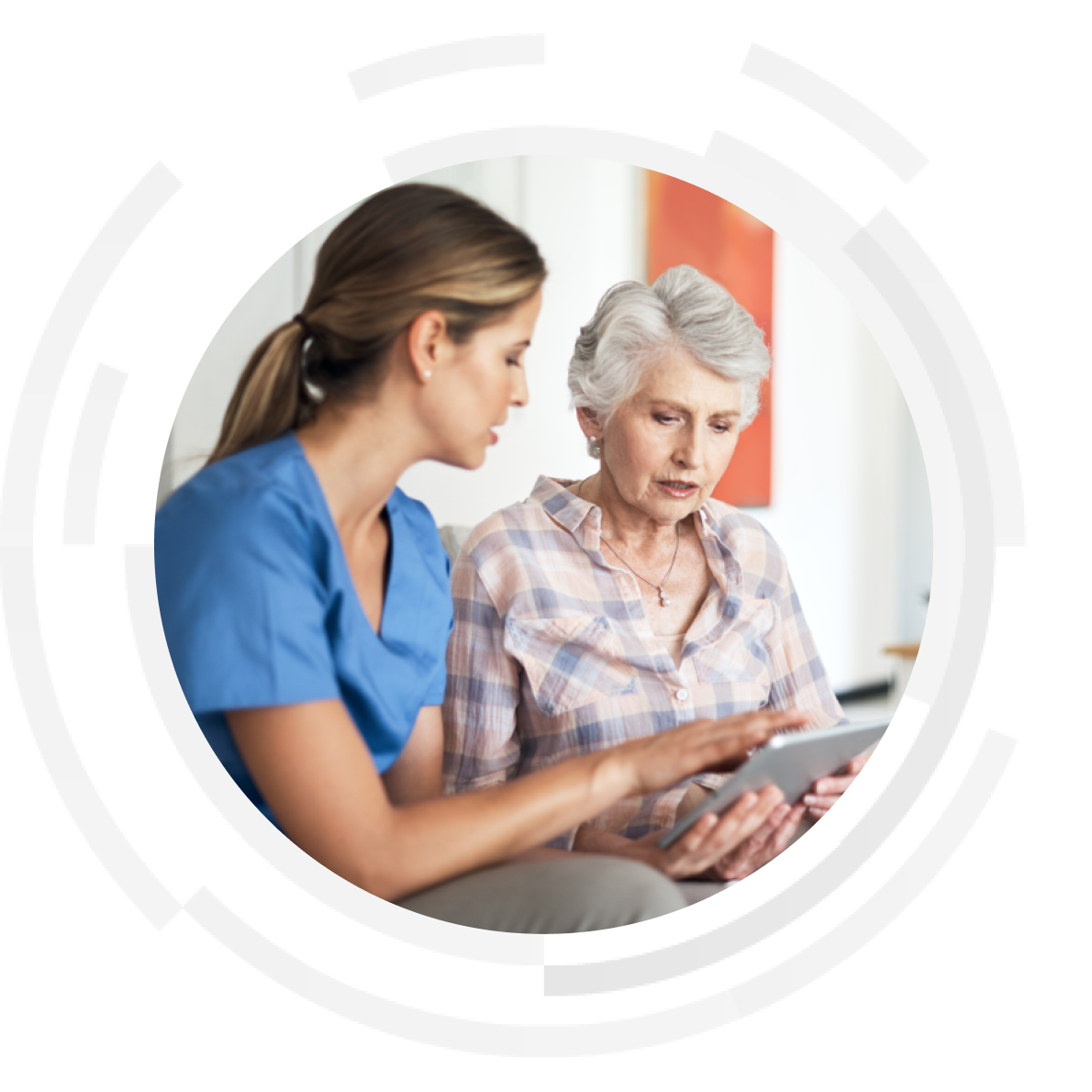 Elderly patient with female nurse looking at a tablet.