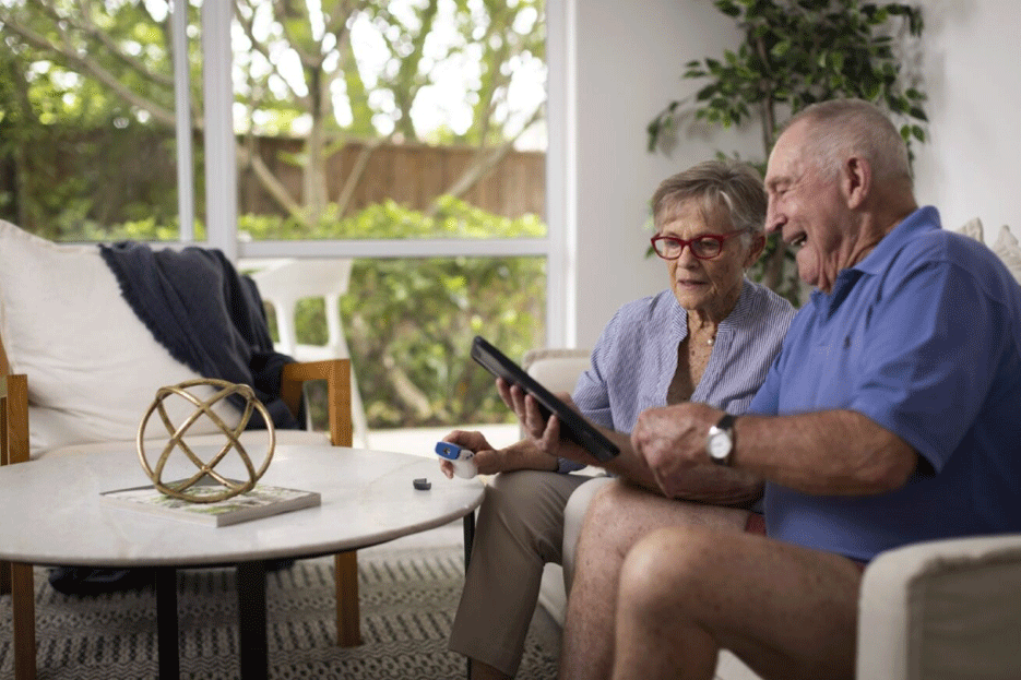 Elderly couple using a tablet device to speak to a clinician