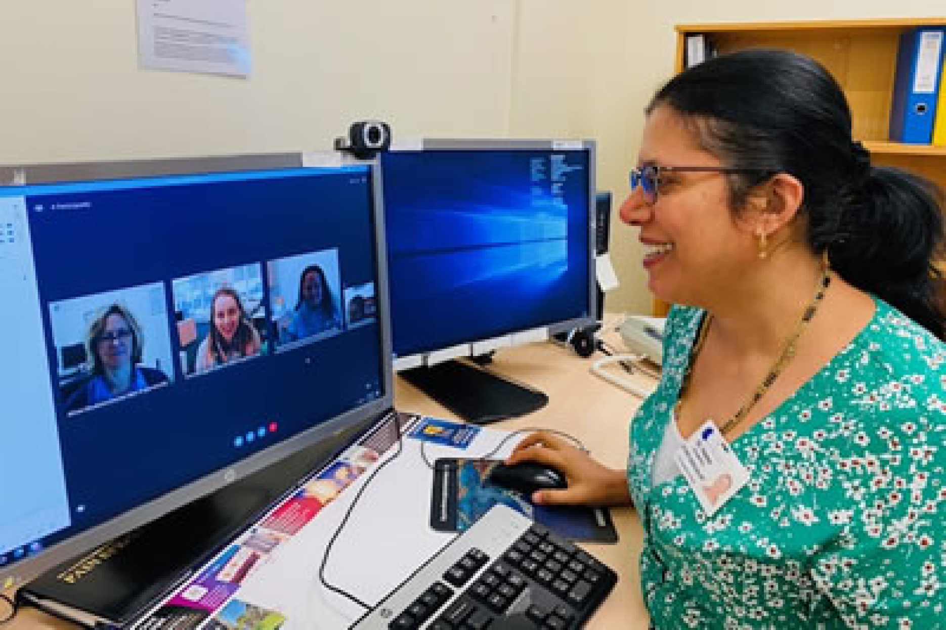 Doctor conducting a telehealth consultation at desktop computer.