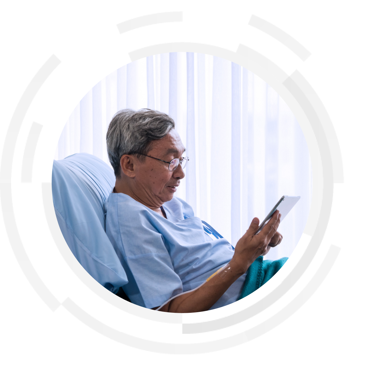 Male patient sitting up in a hospital bed video calling using a tablet device.