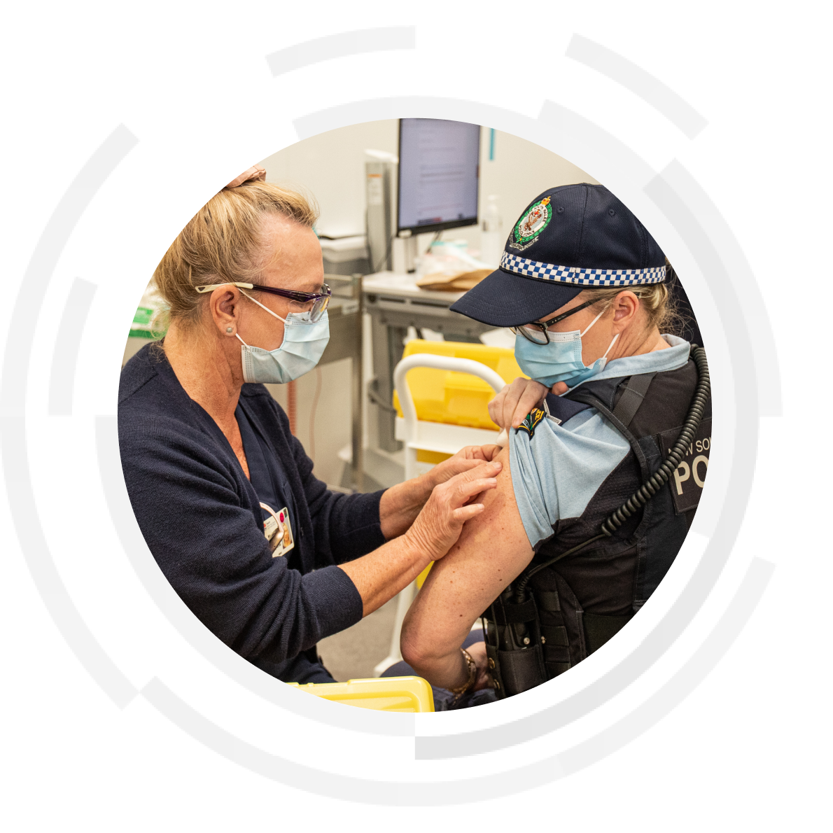 Nurse administering vaccination to a patient who is a female police officer.