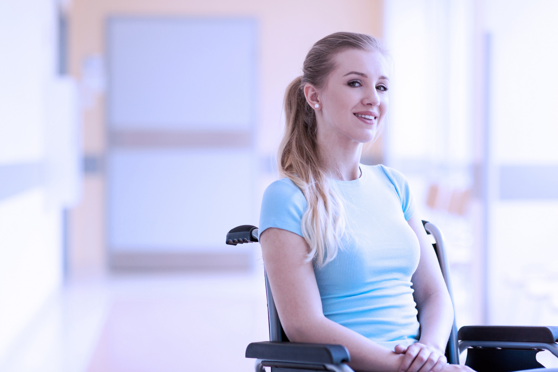 Young female patient sitting in a wheelchair.