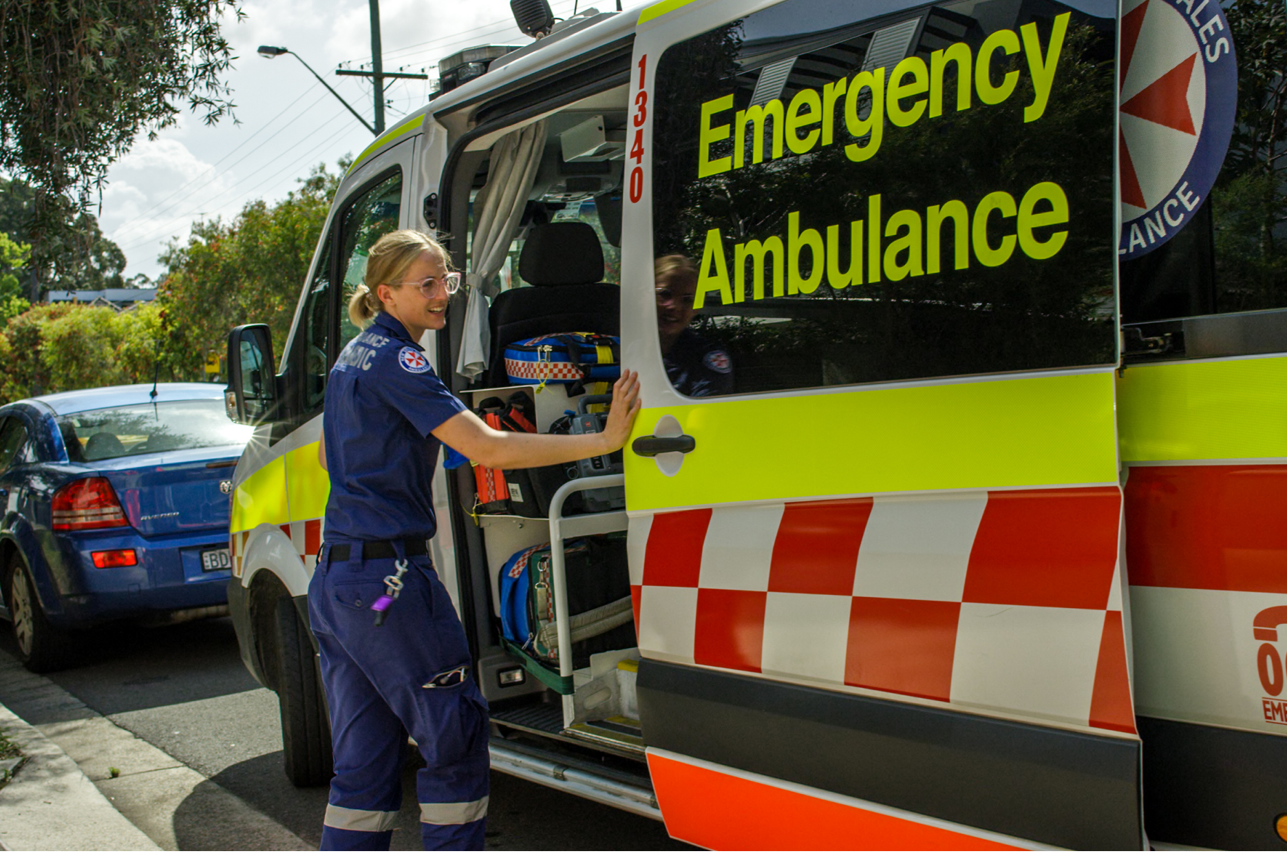 Paramedic opening the door of an ambulance.
